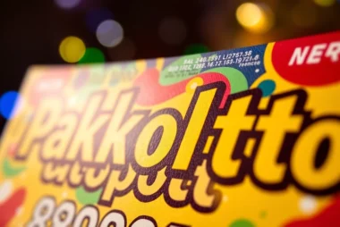 Pakpoltoto lottery ticket being checked for winning, symbolizing hope and anticipation in vibrant colors.